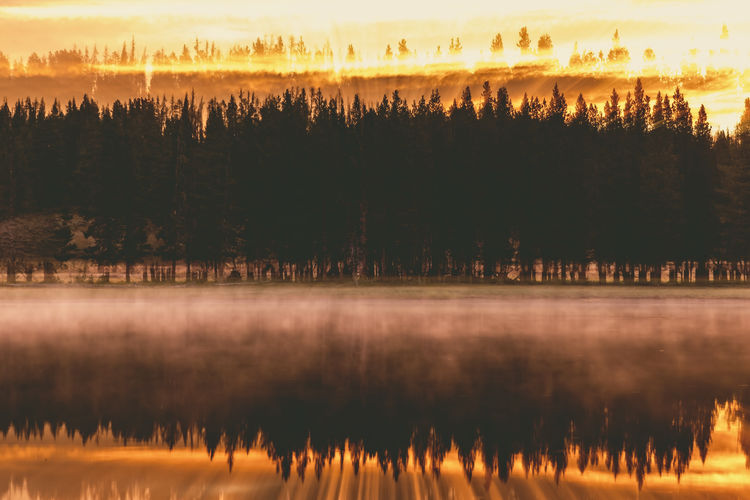 Burning sky, sunrise and morning fog at the lake. yellowstone national park