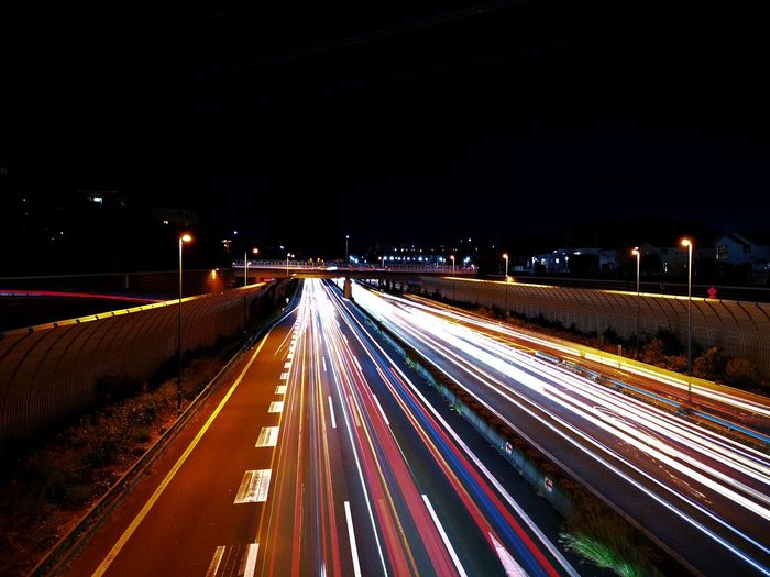 High angle view of light trails on road at night