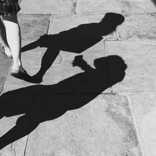 Low section of person standing on shadow