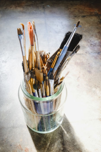 High angle view of paintbrushes in jar on table