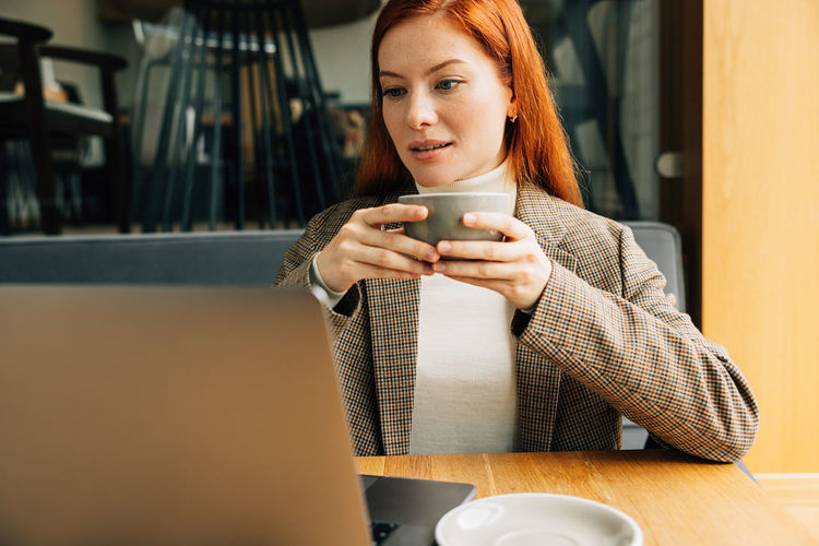 Young woman using mobile phone at home