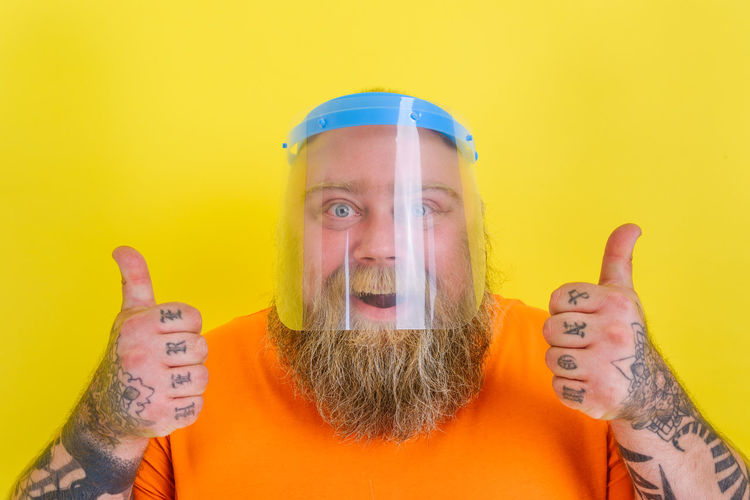 Digital composite image of man against yellow background