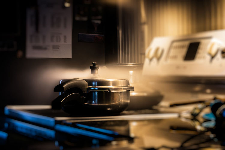 Close-up of steam emitting from utensil on stove