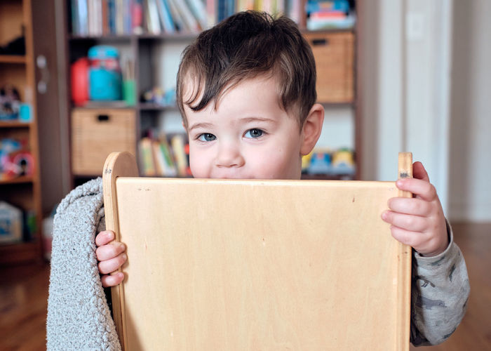 Portrait of cute boy holding cardboard box