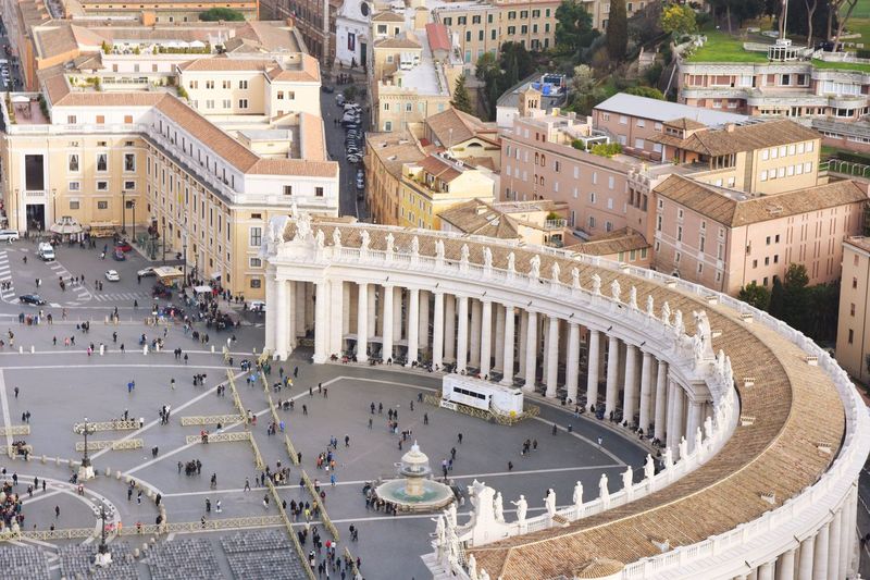 High angle view of people at historic st peter square from basilica