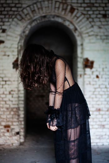 Mysterious woman wearing a black dress