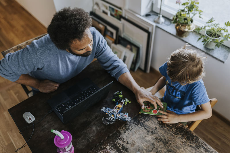 Father working from home and playing with son