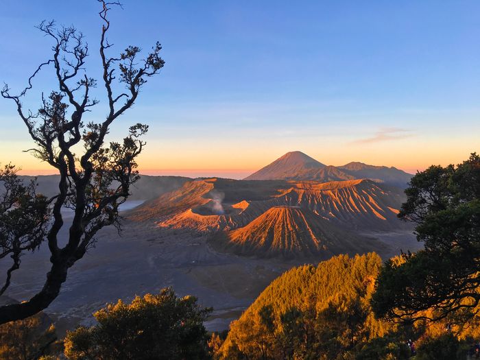 Scenic view of snowcapped mountain against sky during sunset