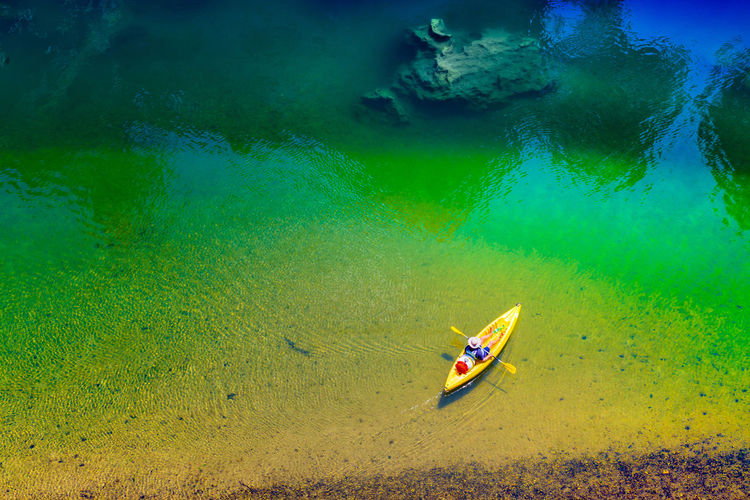 High angle view of person sitting in boat on sea