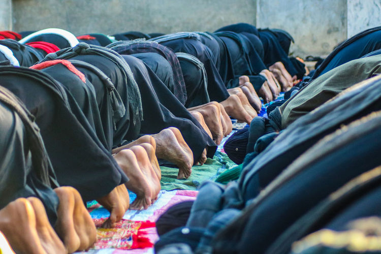 Low section of people praying at mosque