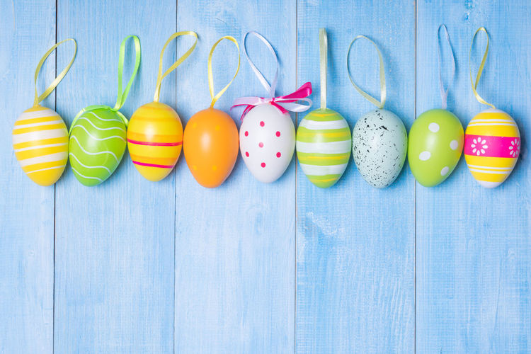 Directly above shot of multi colored eggs on wooden table