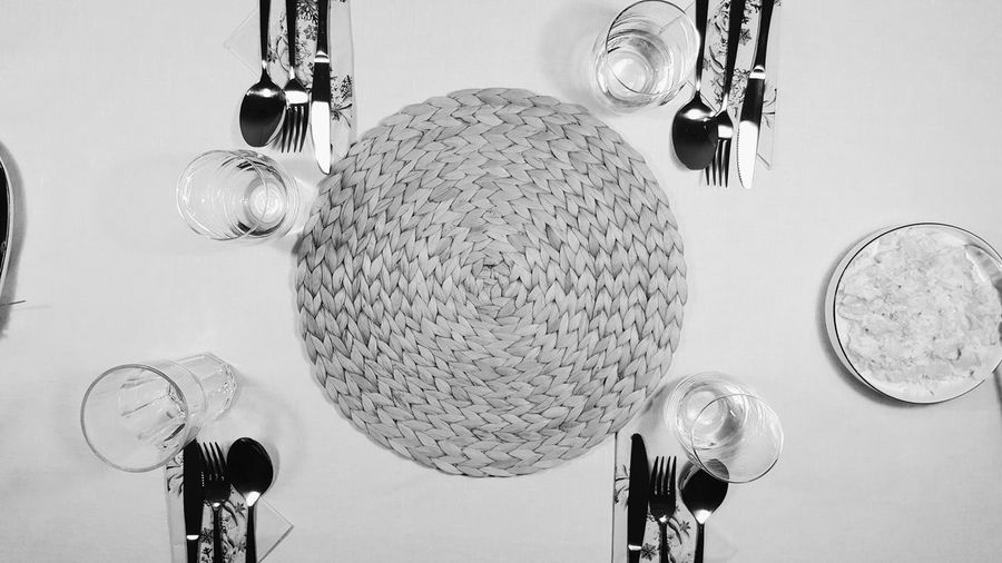 Directly above shot of place mat and cutlery arranged on table