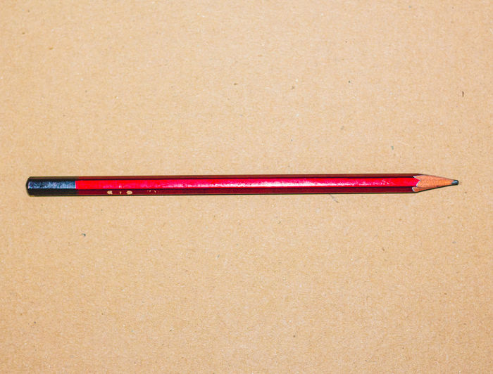 Close-up of colored pencils on table against white background