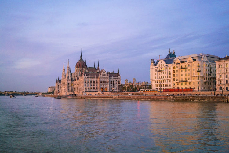 View of the hungarian parliament palace from a cruise boat sunset