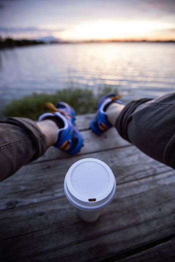 Enjoying coffee by a lake 