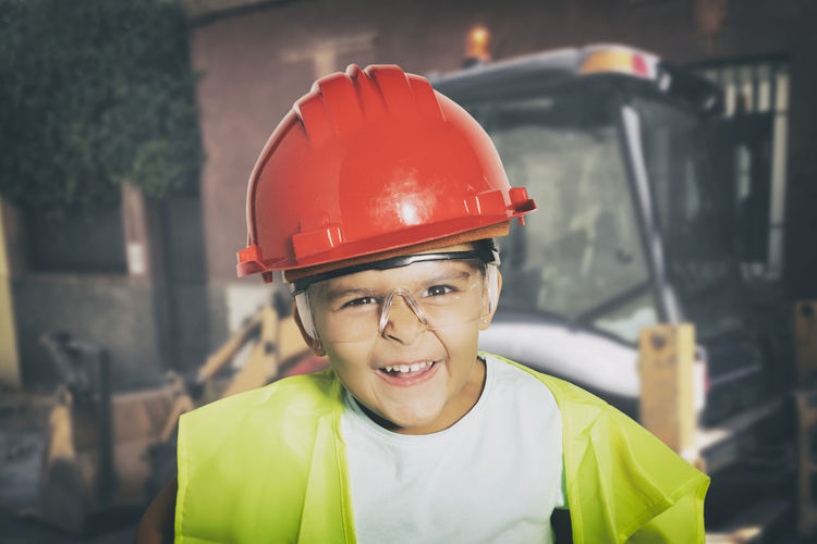 Portrait of smiling boy standing at construction site
