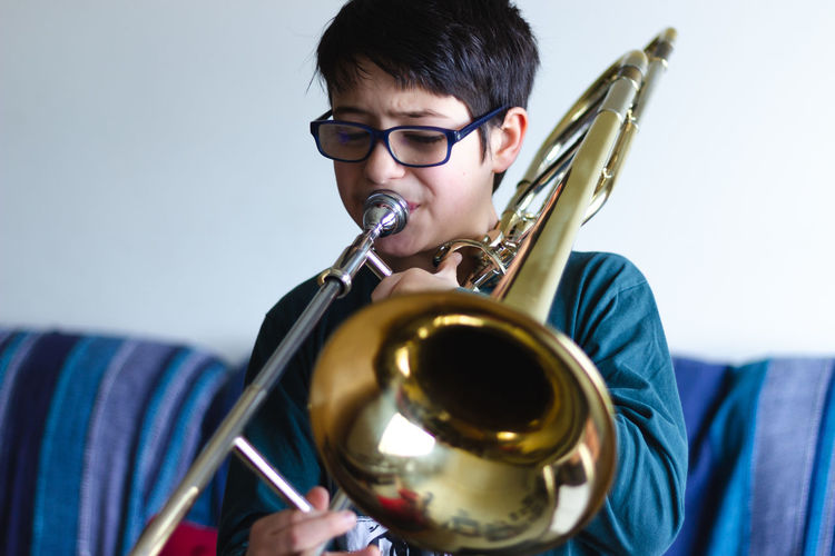 Boy playing trombone at home