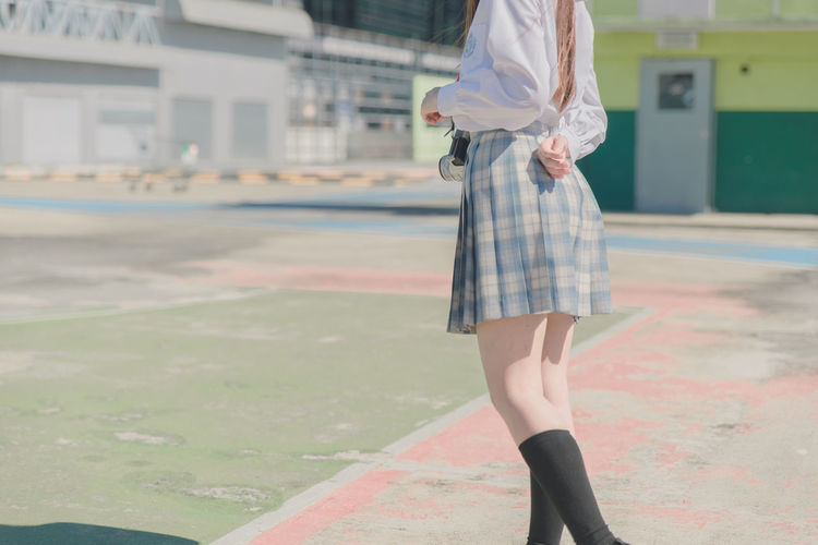 Low section of woman standing outdoors