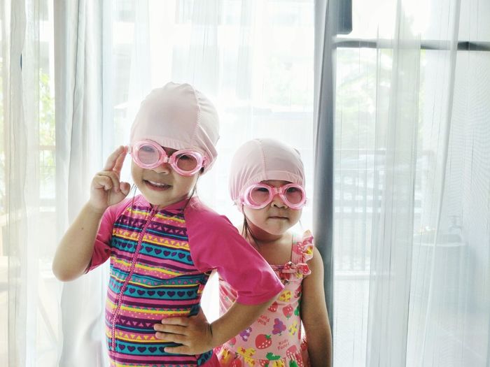 Portrait of cute girls wearing swimming goggles
