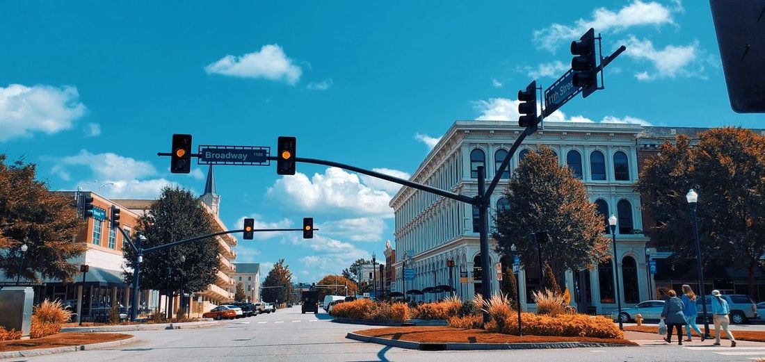 City street and buildings against sky