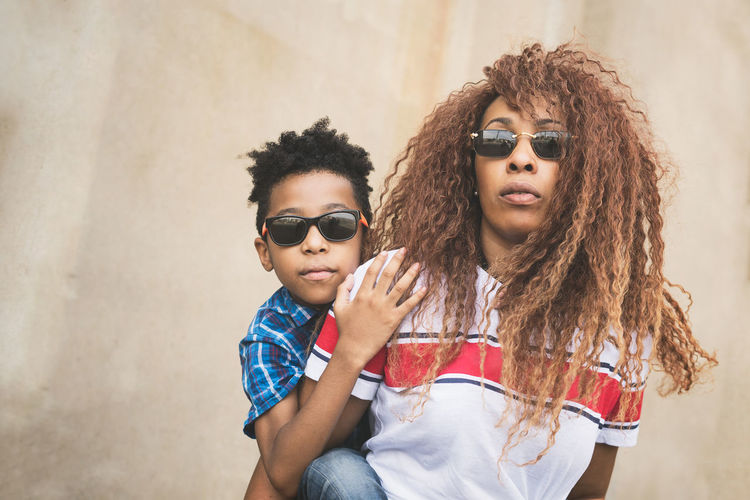 Portrait of mother and son wearing sunglasses outdoors