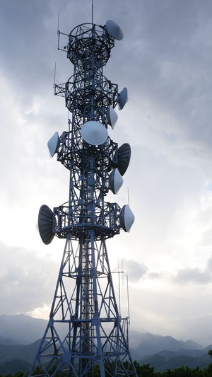 Low angle view of communication tower against sky