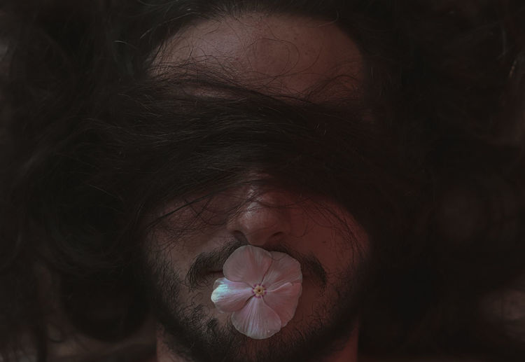 Close-up of man face with flower hair