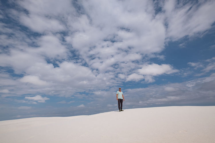 Full length of man standing on desert against sky