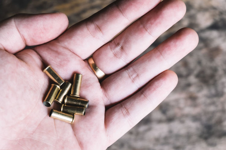 Close-up of hand holding bullets