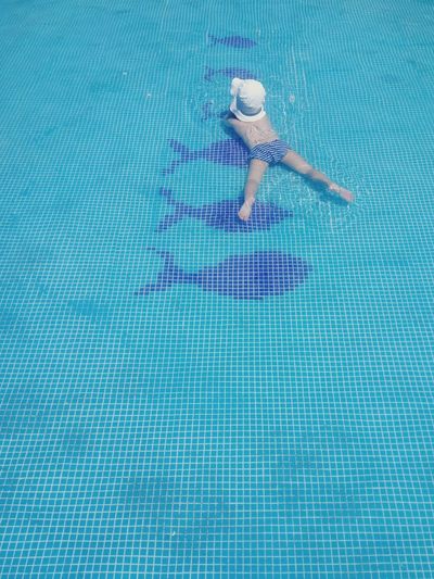 Low section of woman swimming in pool