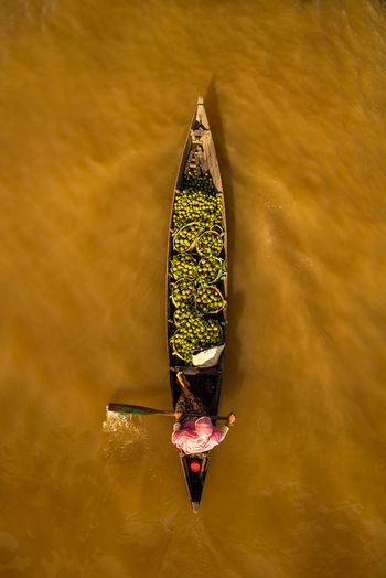 Directly above shot of vendor selling food in boat on lake