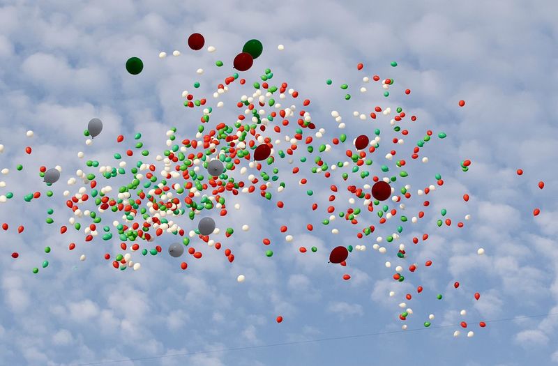 Multi colored balloons against sky
