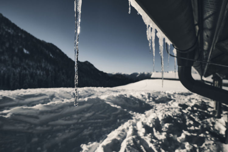 Close-up of stalactites on mountain view covered by the snow.