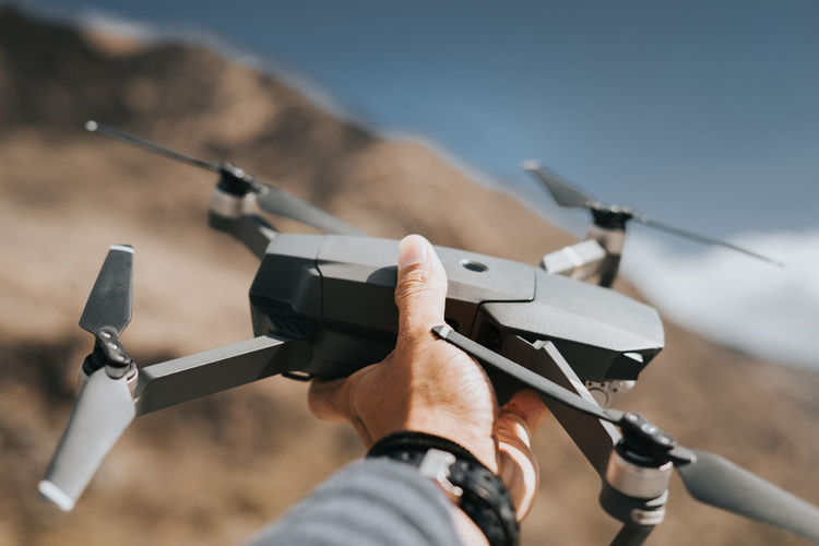 Close-up of hand holding drone