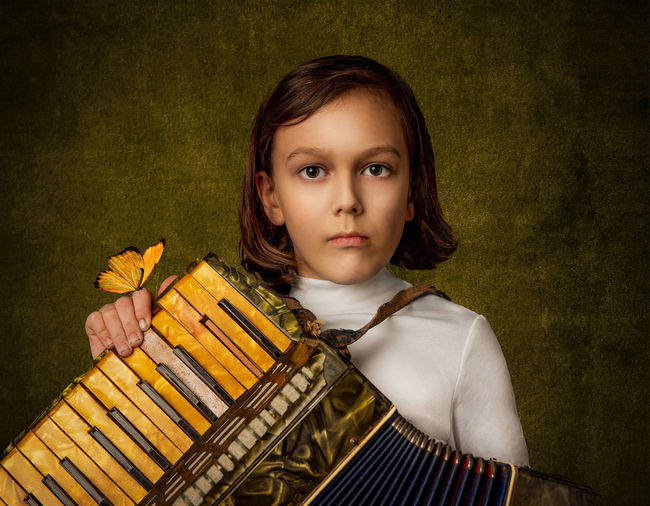 Portrait of a kid playing accordion 