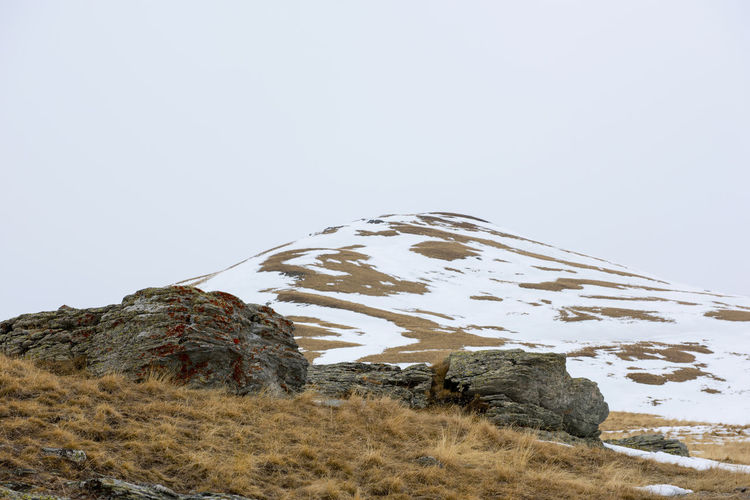 Scenic view of snowcapped mountain against clear sky