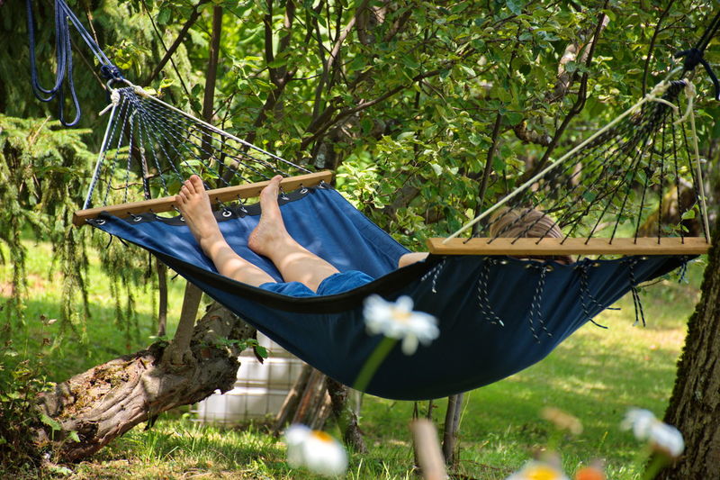 Woman relaxing in hammock during summer holidays