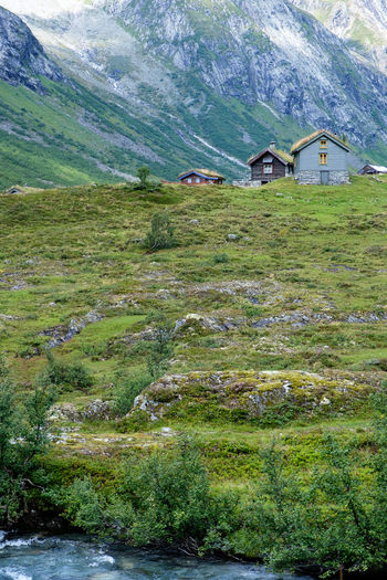 Scenic view of field and houses against mountain