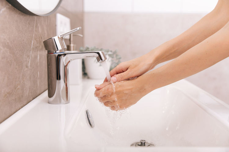 Cropped hand of woman cleaning hands