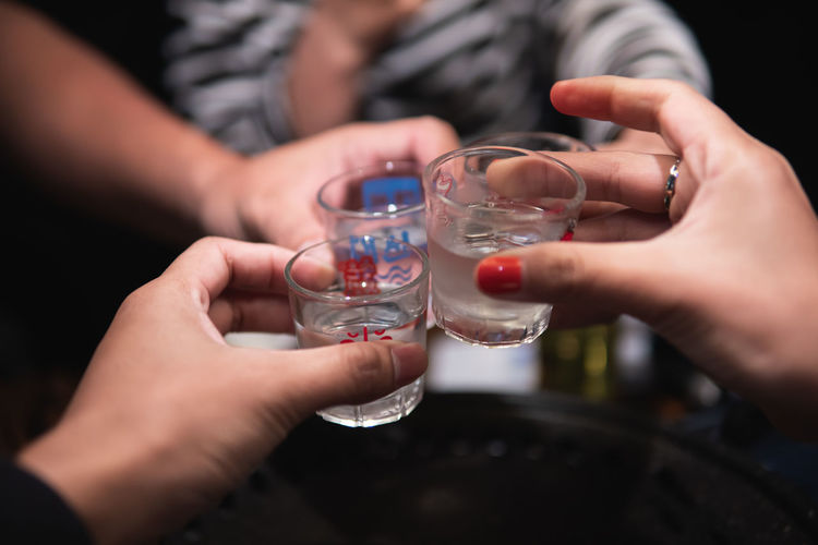 Close-up of hand holding glass of drink
