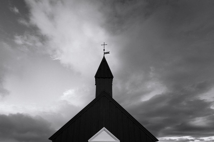 Black church of budir in iceland under stormy sky in black and white