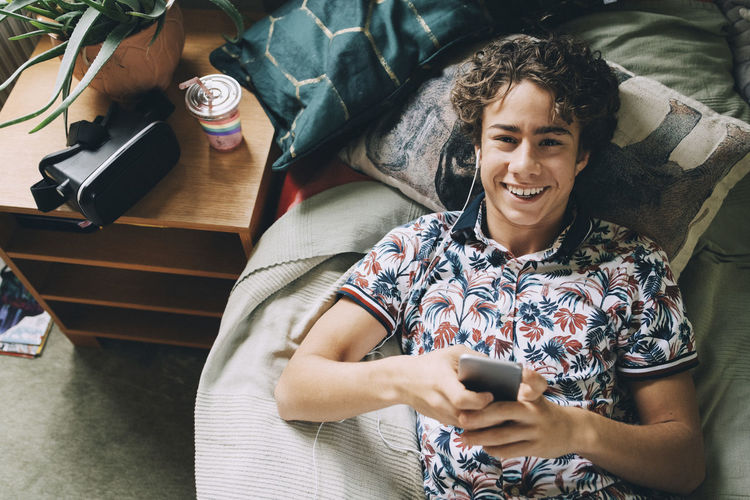 Portrait of smiling young man using mobile phone