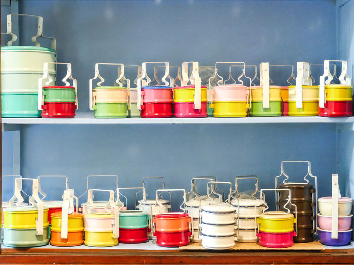 Multi colored lunch boxes on shelf