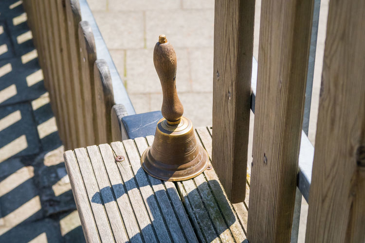 High angle view of bell on wood