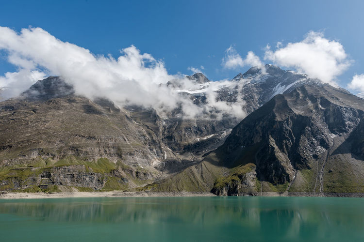 Scenic view of lake and mountains against sky