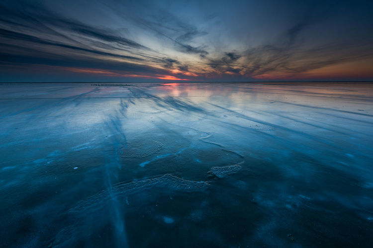 Scenic view of lake against sky during sunset
