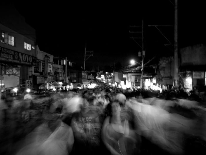 Crowd on street in city at night