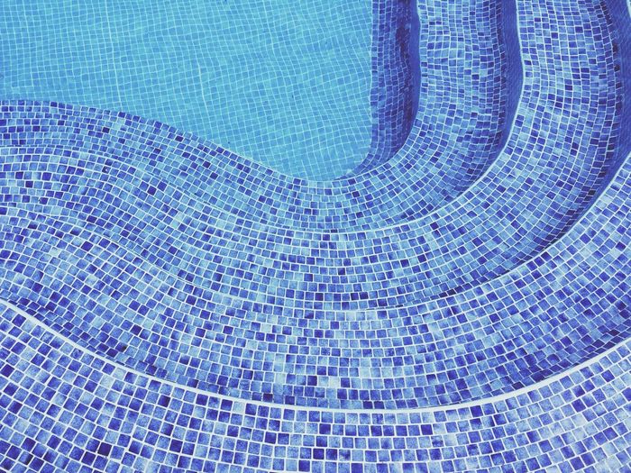 Close-up of cropped stairs in tiled swimming pool
