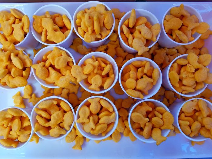 High angle view of cups of fish shaped crackers