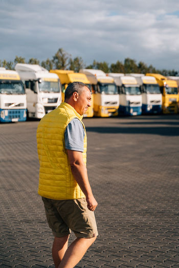 Portrait of caucasian mature man on semi-truck vehicles parking 